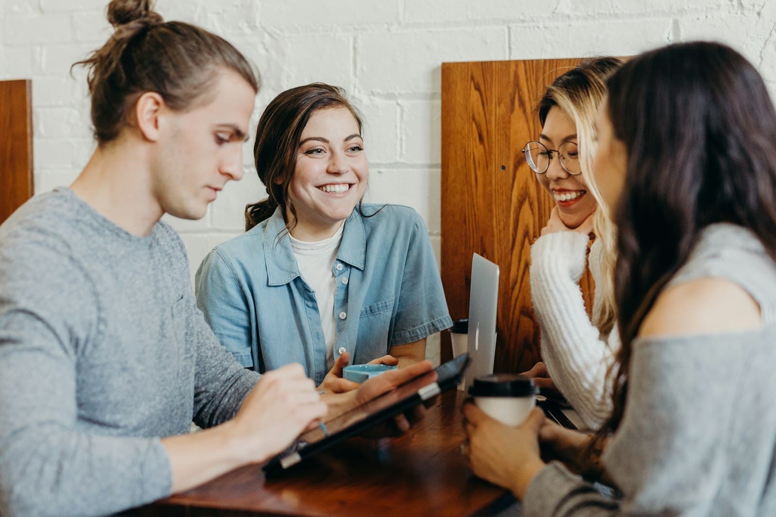 Marketing agency team meeting around a table reviewing performance reports